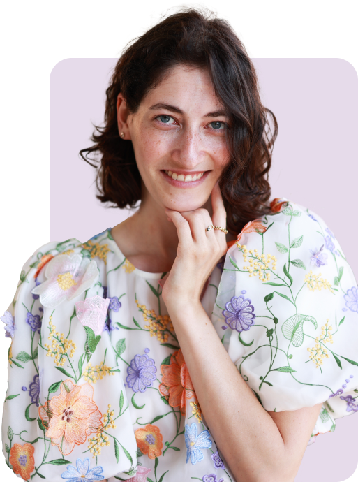 Maya dark hair, blue eyes with flowery shirt smiling